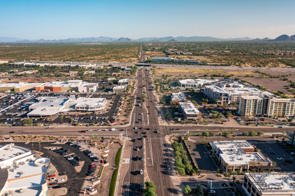 Scottsdale, Arizona Usa October 1 2021: Aerial View Of Commercial And Residential Buildings Along Road With Landscape In The Distance